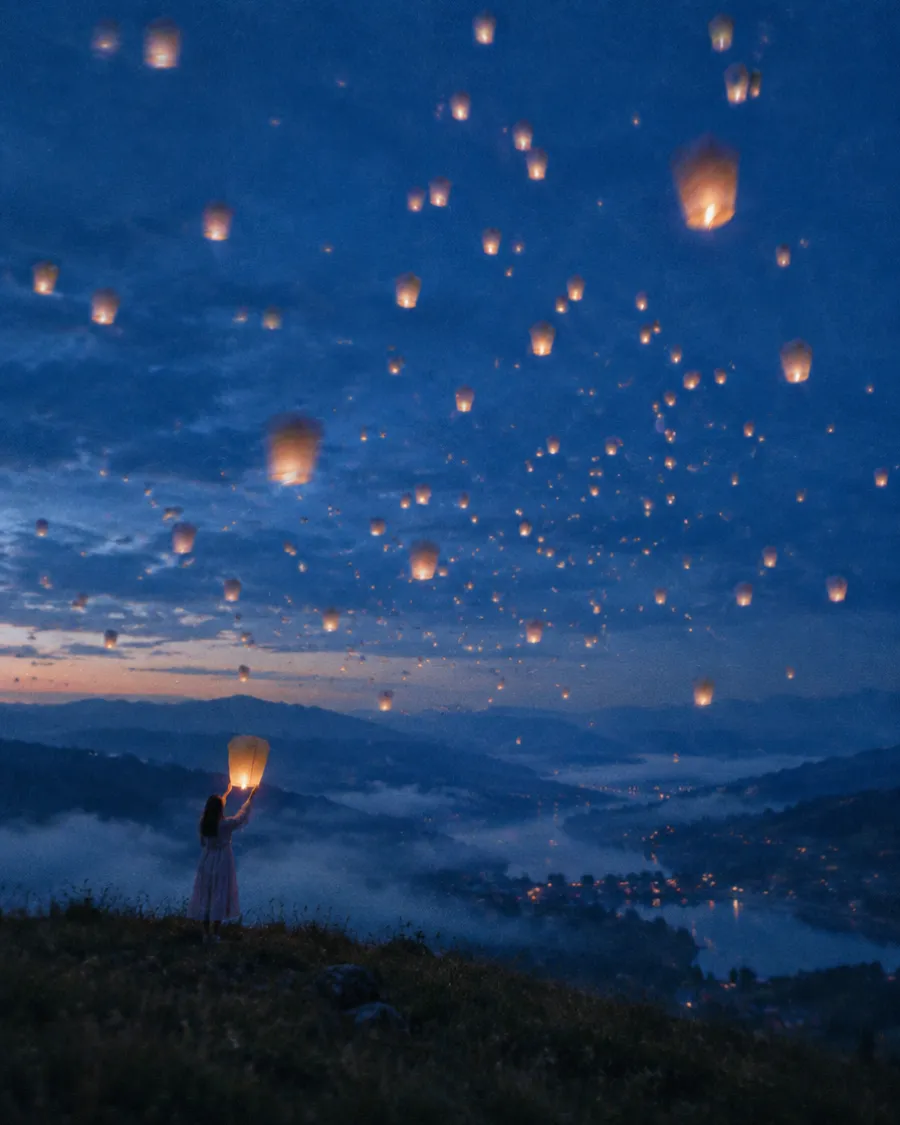 Lanterns rising over a crowd at night